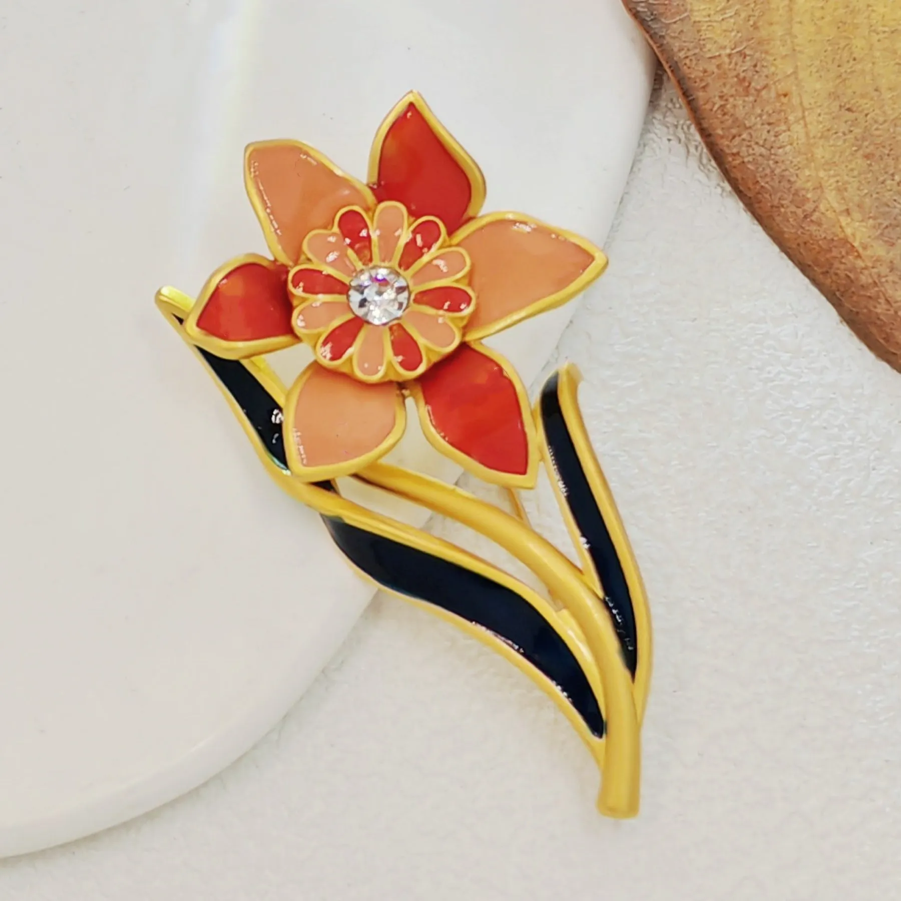 Elegant Gold - toned Enamel Flower Brooch with Crystal Centerpiece
