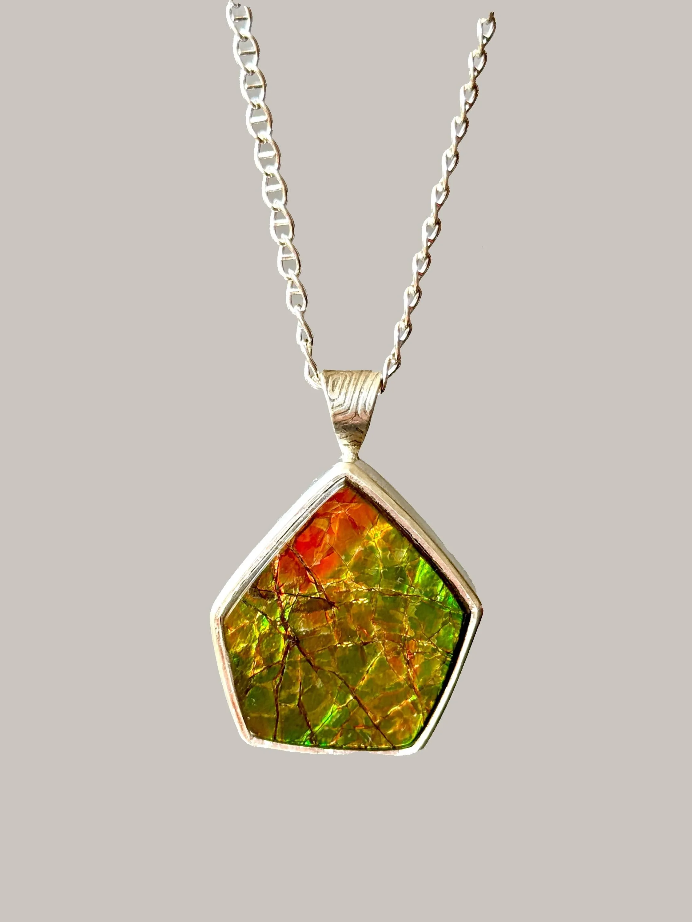 Geometric Ammonite pendant in Sterling Silver, iridescent green